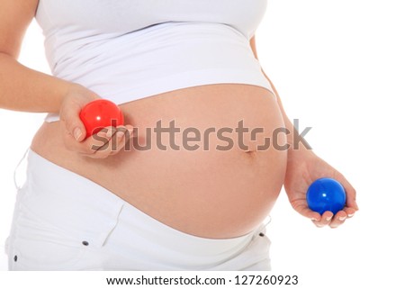 Pregnant woman holding two colorful balls. All on white background.