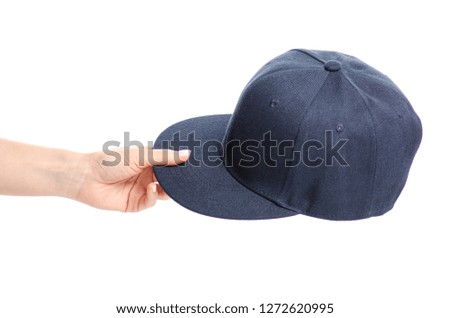 Blue cap in hand on a white background. Isolation