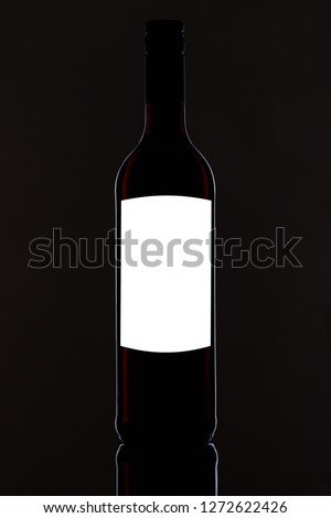 Black red wine bottle with white blank label for text and graphic