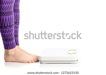Female feet weighing scale on a white background isolation