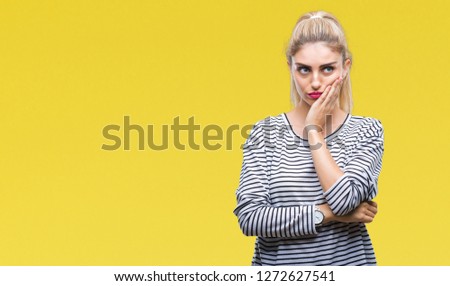 Young beautiful blonde woman wearing stripes sweater over isolated background thinking looking tired and bored with depression problems with crossed arms.