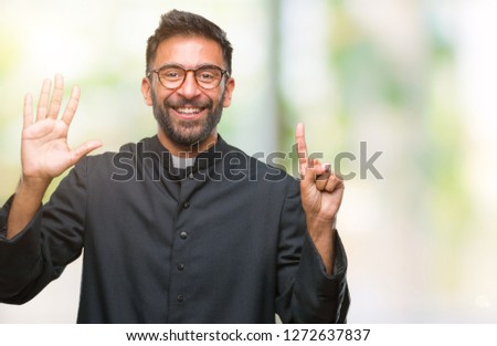 Adult hispanic catholic priest man over isolated background showing and pointing up with fingers number six while smiling confident and happy.