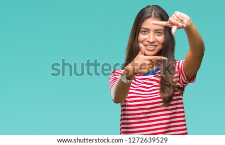 Young beautiful arab woman over isolated background smiling making frame with hands and fingers with happy face. Creativity and photography concept.