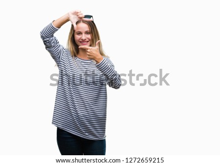 Young beautiful blonde woman wearing sunglasses over isolated background smiling making frame with hands and fingers with happy face. Creativity and photography concept.