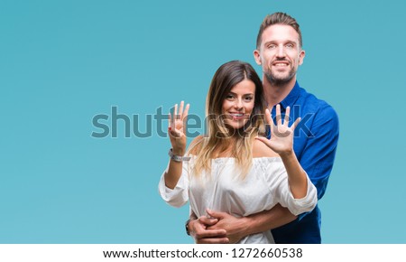 Young couple in love over isolated background showing and pointing up with fingers number nine while smiling confident and happy.