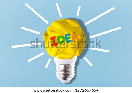 crumpled yellow paper light bulb with colorful inscription idea, inspirational image