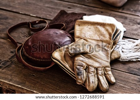 leather gloves old beige weathered protection falconry hip flask close-up