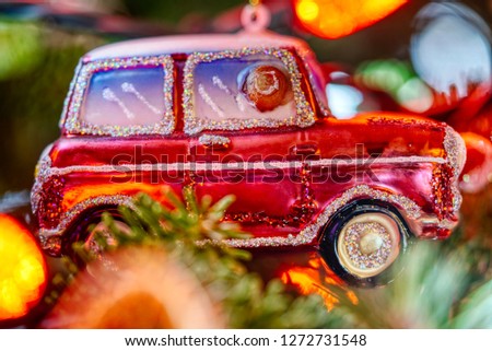 Traditional Christmas car decoration hanging on a Christmas tree.                      