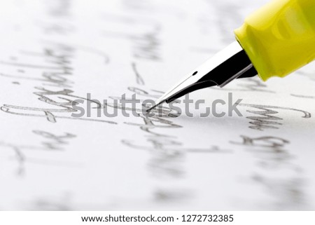 yellow fountain pen writing a letter