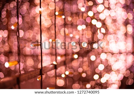 Pink bokeh blurred lights background. Rose garlands decoration for the new year festival celebration.