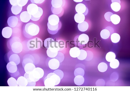 Purple bokeh blurred lights background. Violet garlands decoration for the new year celebration.