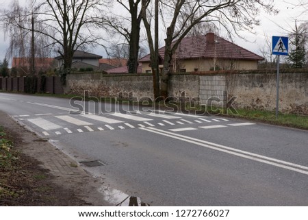 an unusual pedestrian crossing into the wall