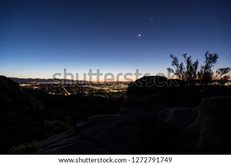 Sunrise hilltop view of sprawling west San Fernando Valley neighborhoods in Los Angeles, California.