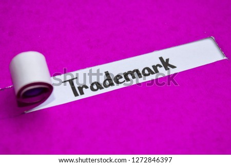 Trademark text, Inspiration, Motivation and business concept on purple torn paper