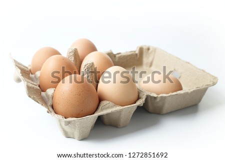 chicken eggs in egg box on white background 