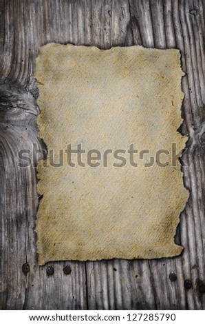 Old paper on rustic wooden background