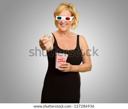 Happy Elderly Woman Wearing 3d Glasses Holding Popcorn And Ticket On Grey Background