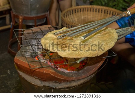 Khao Kriap Wow, thai dessert as thin flour flapped cook over the fire