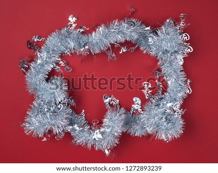 Decorative ribbons above red background