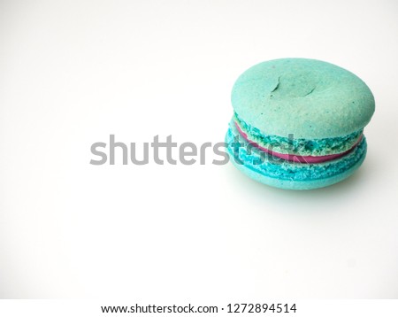 Single French Blue macaroon on the white background. Top view. Flat lay