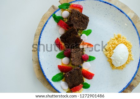 chocolate nut brownie cake decorated with strawberries. the toning. selective focus
