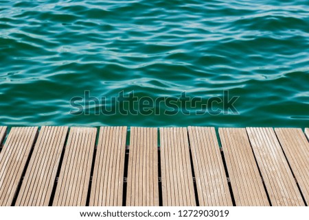 wooden deck waterfront outdoor exterior floor perspective background texture and sea water surface wallpaper pattern with empty space for copy or your text