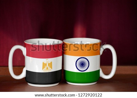 India and Egypt flag on two cups with blurry background