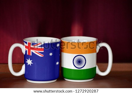 India and Australia flag on two cups with blurry background