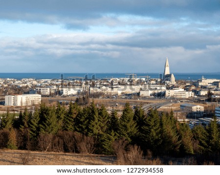 Cityscape of Reykjavik, capital city of Iceland, under cloudy blue sky from Perlan Observatory deck viewpoint