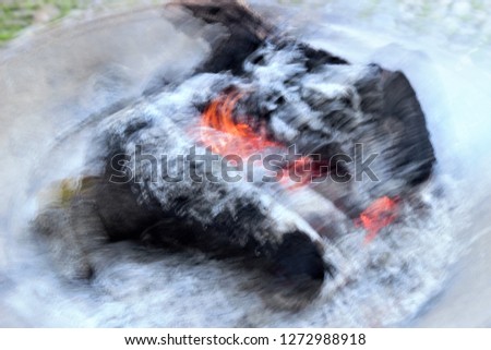 Tribute to Monet, tribute to Ernst Hass, impressionist photograph of burning trunk,  impressionistic and abstract photography at low shutter speed, photographic sweeps.