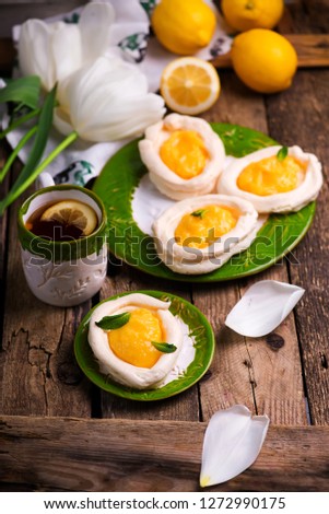egg shaped meringue nests with lemon curd .traditional  easter pastries. selective focus