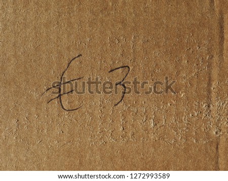 3 Euro price written on brown corrugated cardboard
