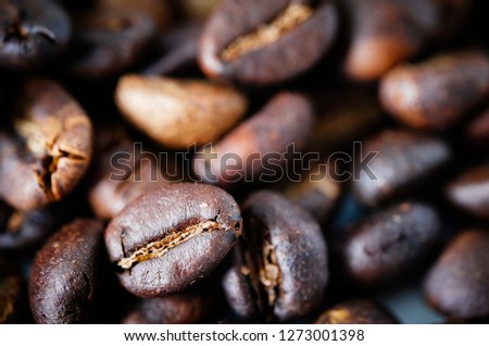 Coffee beans background texture background with copy space for text. Royalty high-quality free stock macro photo image of roasted black coffee beans, coffee beans background. Close-up or macro photo