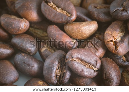 Coffee beans background texture background with copy space for text. Royalty high-quality free stock macro photo image of roasted black coffee beans, coffee beans background. Close-up or macro photo