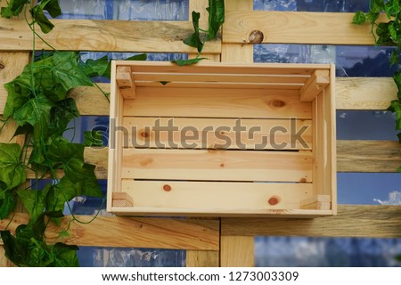 Top view of  empty wooden crate hang on wall.