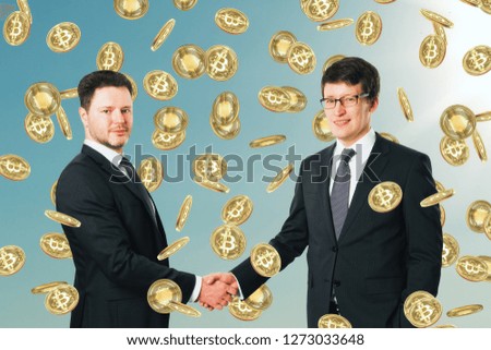 Businessmen celebrating golden bitcoin rain on sky background. Cryptocurrency and finance concept 