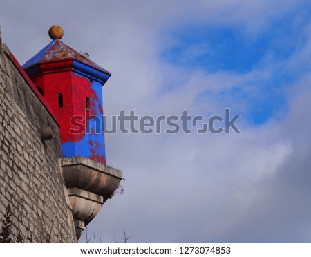 Photography that is showing a small red and blue tower in the Chartreuse mountain near Grenoble, France