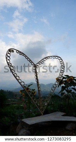 love sign from bamboo, with a background of scenery and blue sky