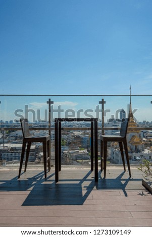 two chair at terrace restaurant with temple in bangkok view background