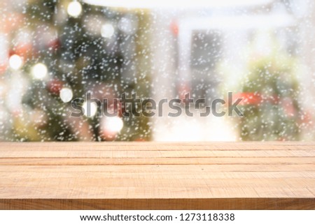 Empty wooden table and decorated christmas tree, Xmas and New Year abstract background.  copy space, snow effect