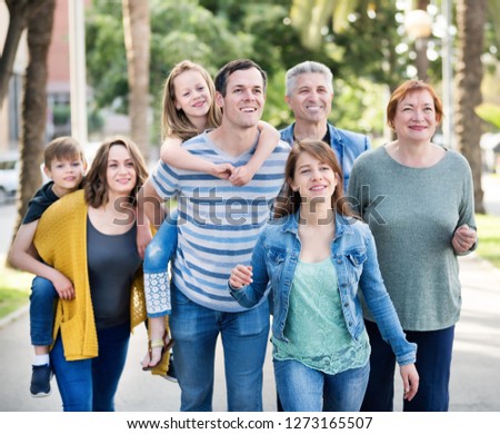 Friendly and glad family going in park on weekend together 