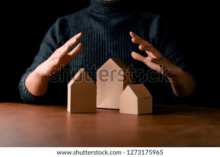 house design solution man hand with house paper model and equipment