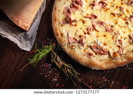 Top view on pizza with ingridients. Cheese, herbs and spices on brown background. italian food. Traditional italian cuisine set. Picture for recipe. Copy space for text logo or brand.