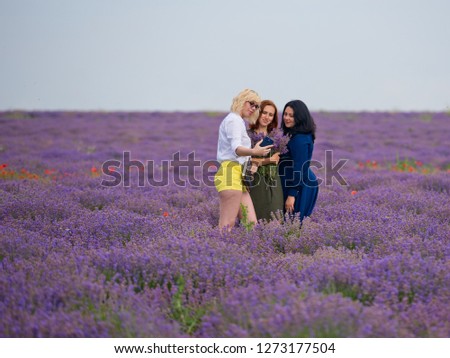 Three girls make selfie in a lavender field.