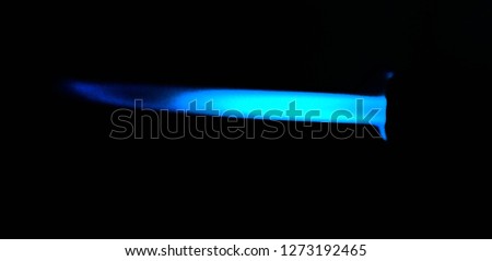 The blue fire is released in a long horizontal line on black background.
