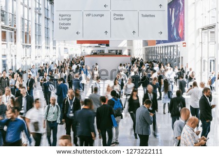 blurred people walking in a modern hall of a trade fair