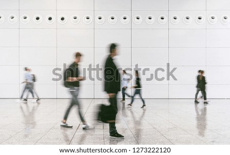 crowd of people walking on a trade show