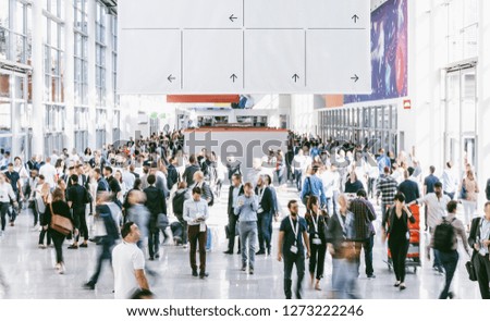 Crowd of people walking on a trade show in london