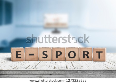 E-sport sign on a desk in a blue room with a blurry background