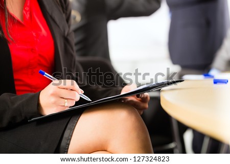 Business - businesspeople have a meeting with presentation in office, they negotiate a contract - closeup